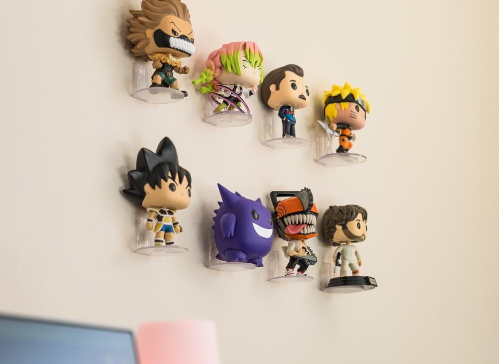 Eight collectible vinyl figures on clear Modern JP figure wall shelves